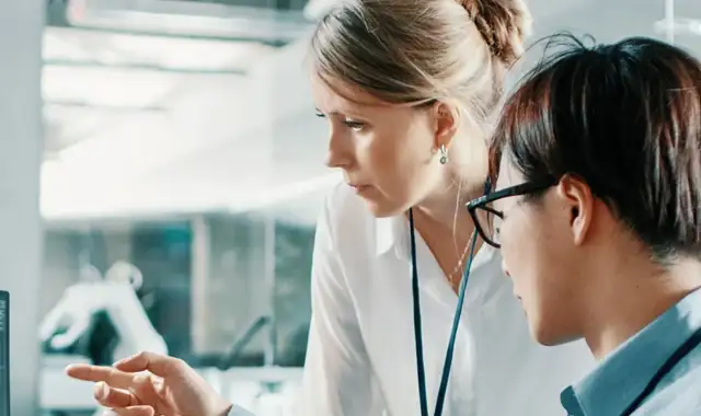 Two people discussing something on a screen