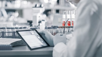 Person in cleanroom with tablet