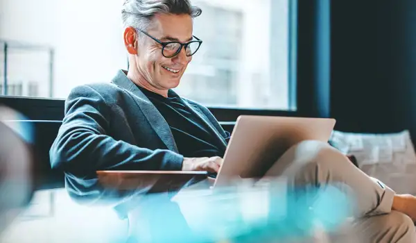Man smiling at computer